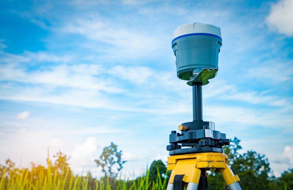 GPS surveying instrument on blue sky