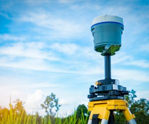 GPS surveying instrument on blue sky